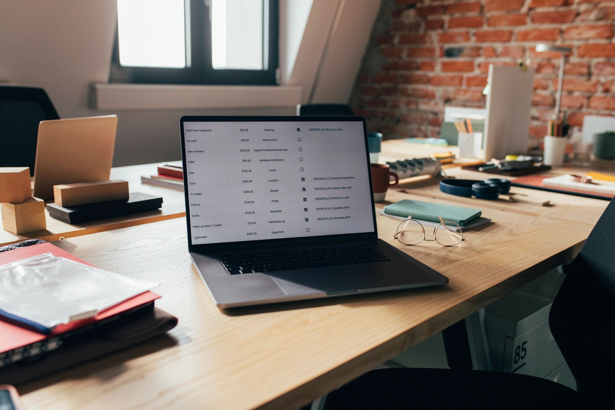 Open laptop on a desk in a modern coworking office